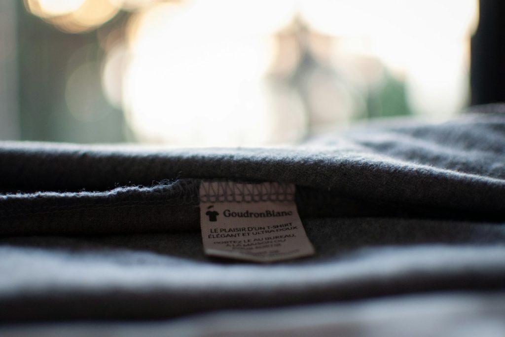 A small fabric label inside the waistband of dark jeans