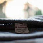 A small fabric label inside the waistband of dark jeans